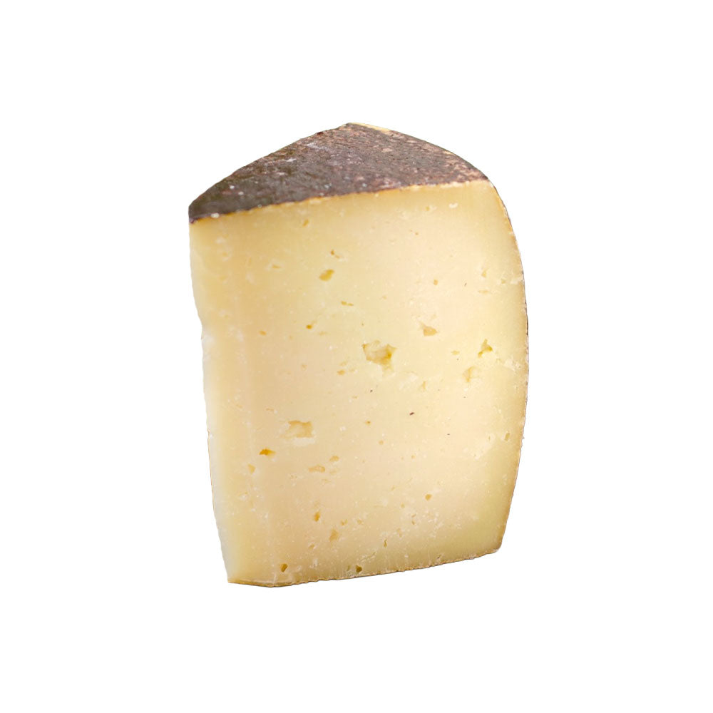 The Cheese Man aged Sardinian goat cheese, a firm artisanal cheese with a tangy, earthy flavour and slightly crumbly texture, showcasing traditional Italian goat’s milk cheese for gourmet cheese boards.