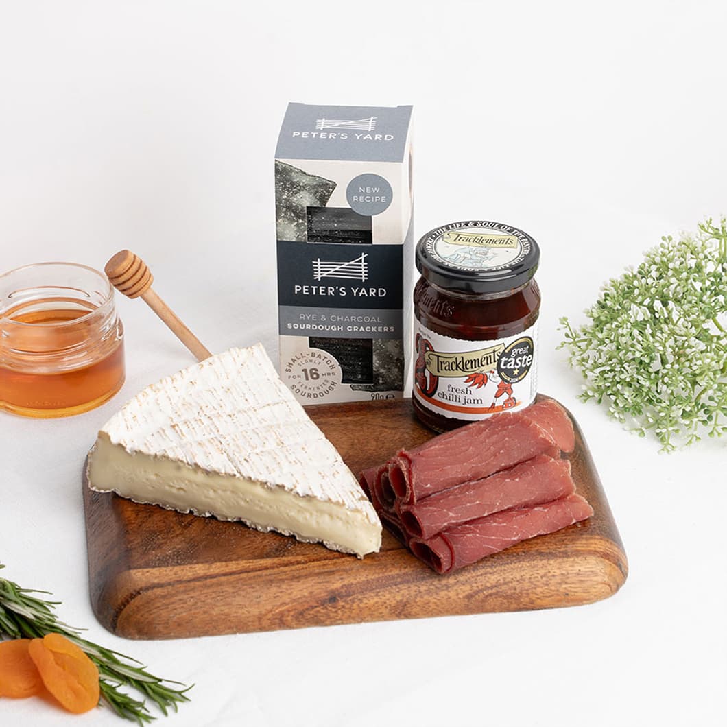 A carefully curated selection featuring Brie de Meaux, cured beef and gourmet accompaniments for effortless treat at home.