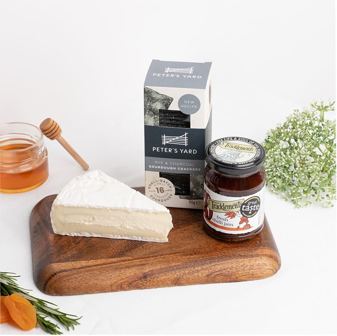 Creamy Brie cheese paired with artisan crackers and chilli jam, curated for an elegant cheese board experience. Available for premium cheese delivery in Dubai. Free delivery on orders over AED249.