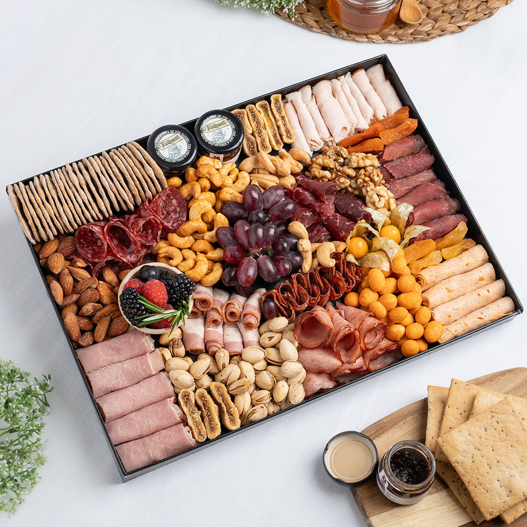 The Cheese Man luxury charcuterie board featuring halal cold cuts, smoked meats, salami, crackers, nuts, grapes, dried fruits, and gourmet accompaniments, curated for premium grazing platters and charcuterie boxes in Dubai. Available for delivery across UAE. Free delivery over AED249.