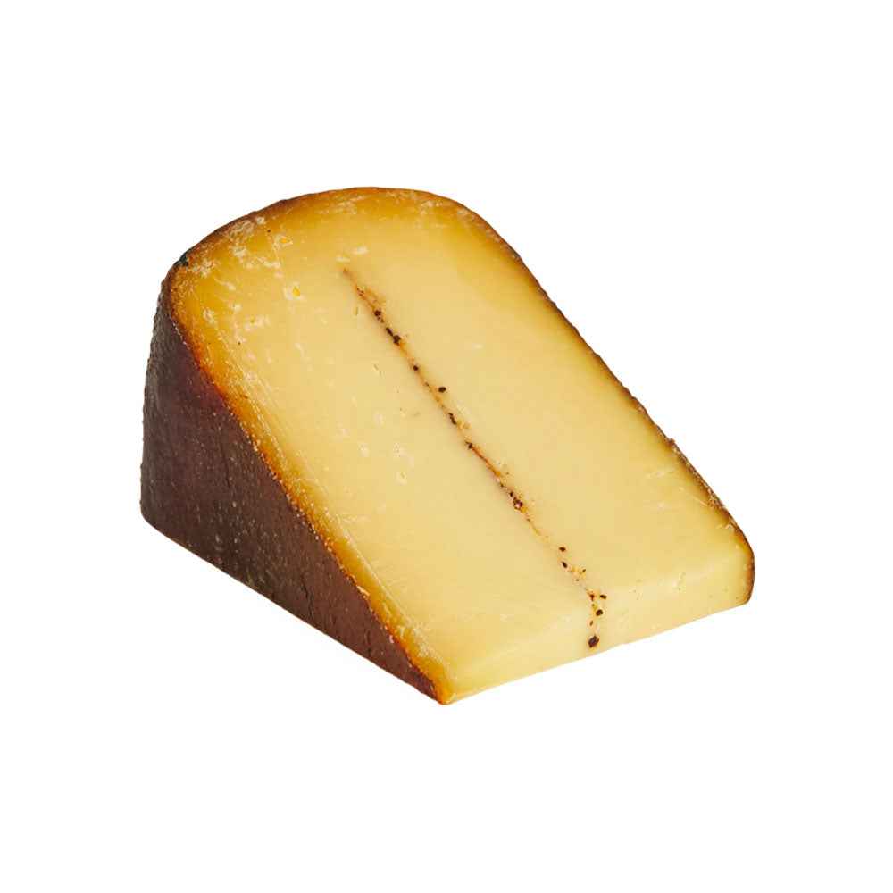 A wedge of semi-hard coffee-infused cheese with a smooth pale-yellow interior, natural brown rind, and a subtle coffee line running through the centre, offering a rich savoury flavour for gourmet cheeseboards and pairings.