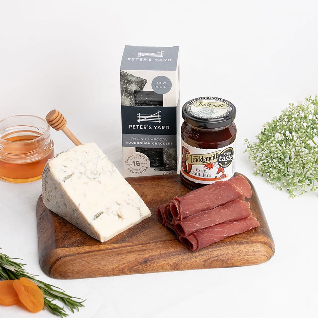 Blue-veined Gorgonzola with premium cured meat and artisan crackers, adding depth, creaminess and character to a sophisticated cheese experience.