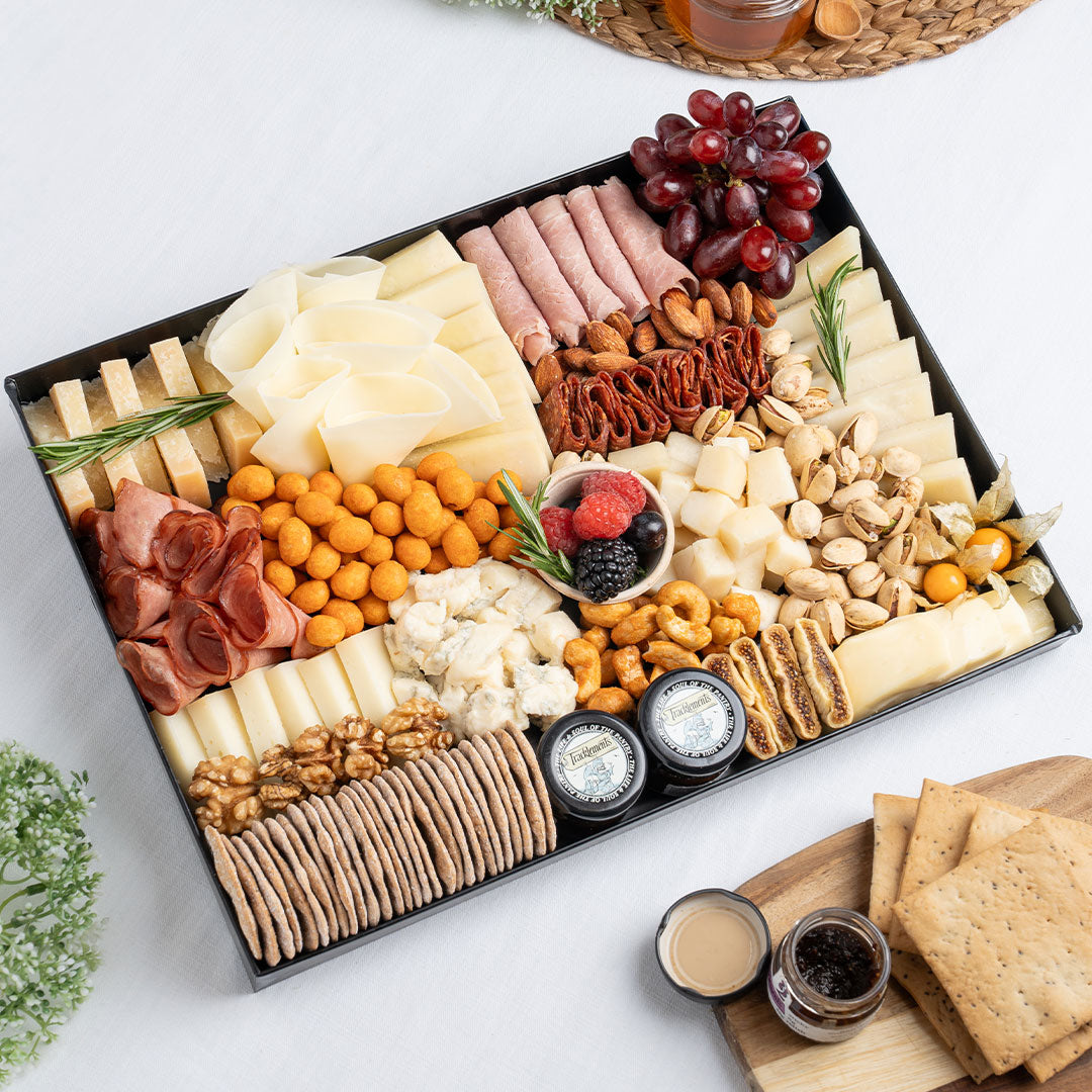 The Cheese Man Italian cheese platter featuring parmesan, artisan Italian cheeses, halal cold cuts, crackers, nuts, grapes, figs, and gourmet accompaniments, curated for luxury charcuterie boards and cheese platters in Dubai. Available for delivery across UAE. Free delivery over AED249.
