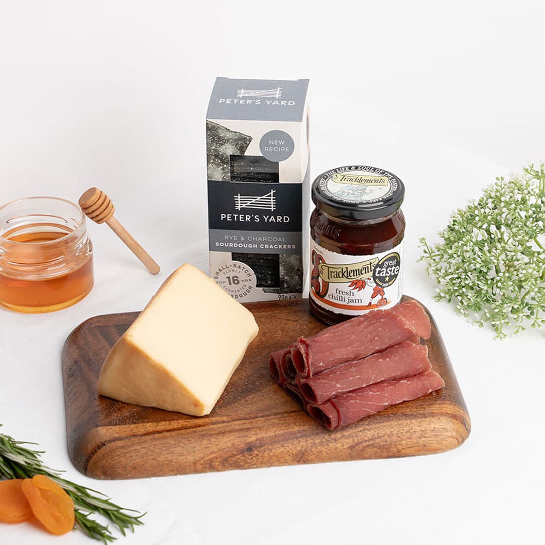 Oakwood smoked cheese paired with premium charcuterie, artisan crackers and chilli jam for a rich and savoury gourmet tasting experience.