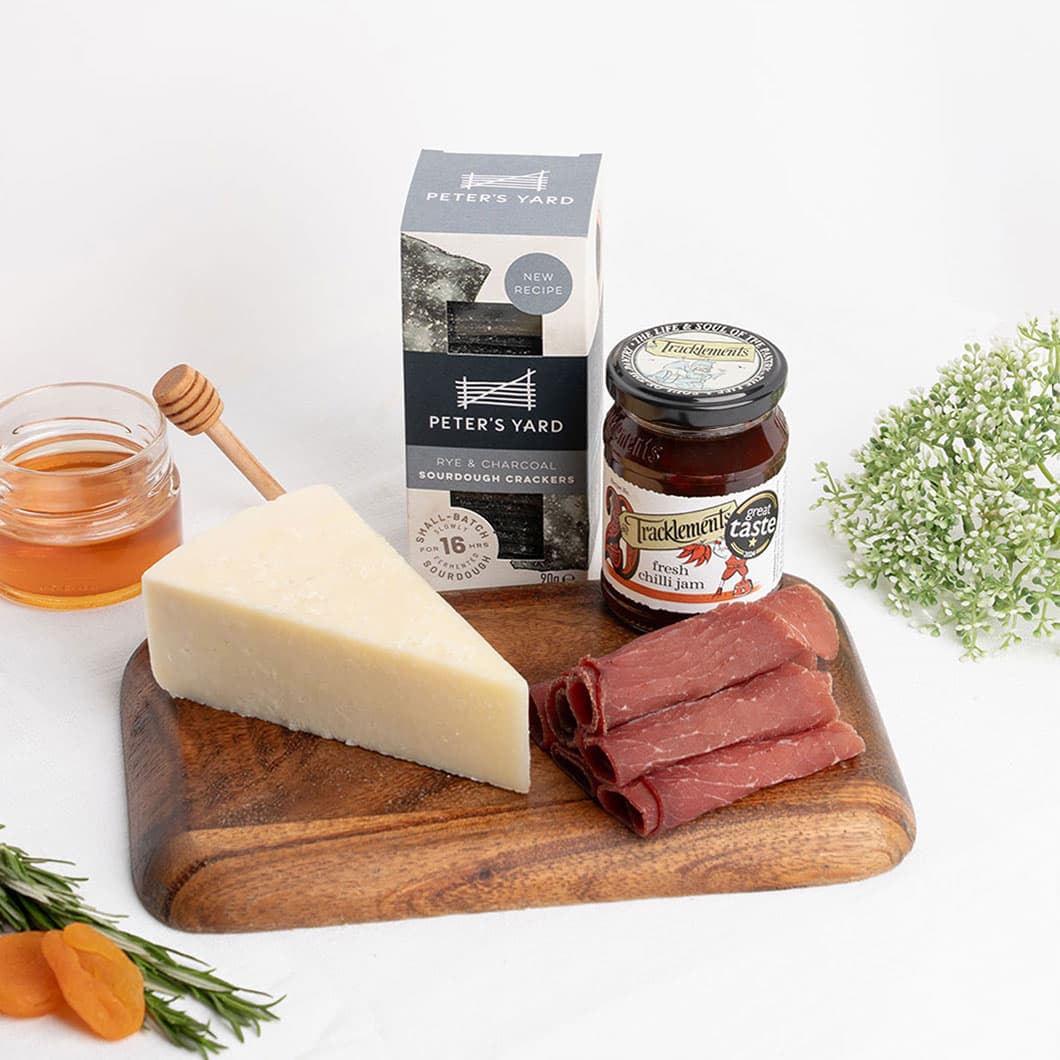 Aged sheep's milk cheese served with cured meat and gourmet accompaniments, showcasing bold Mediterranean flavours. Pecorino Romano paired with premium charcuterie, artisan crackers and chilli jam for a classic Italian-inspired tasting experience.