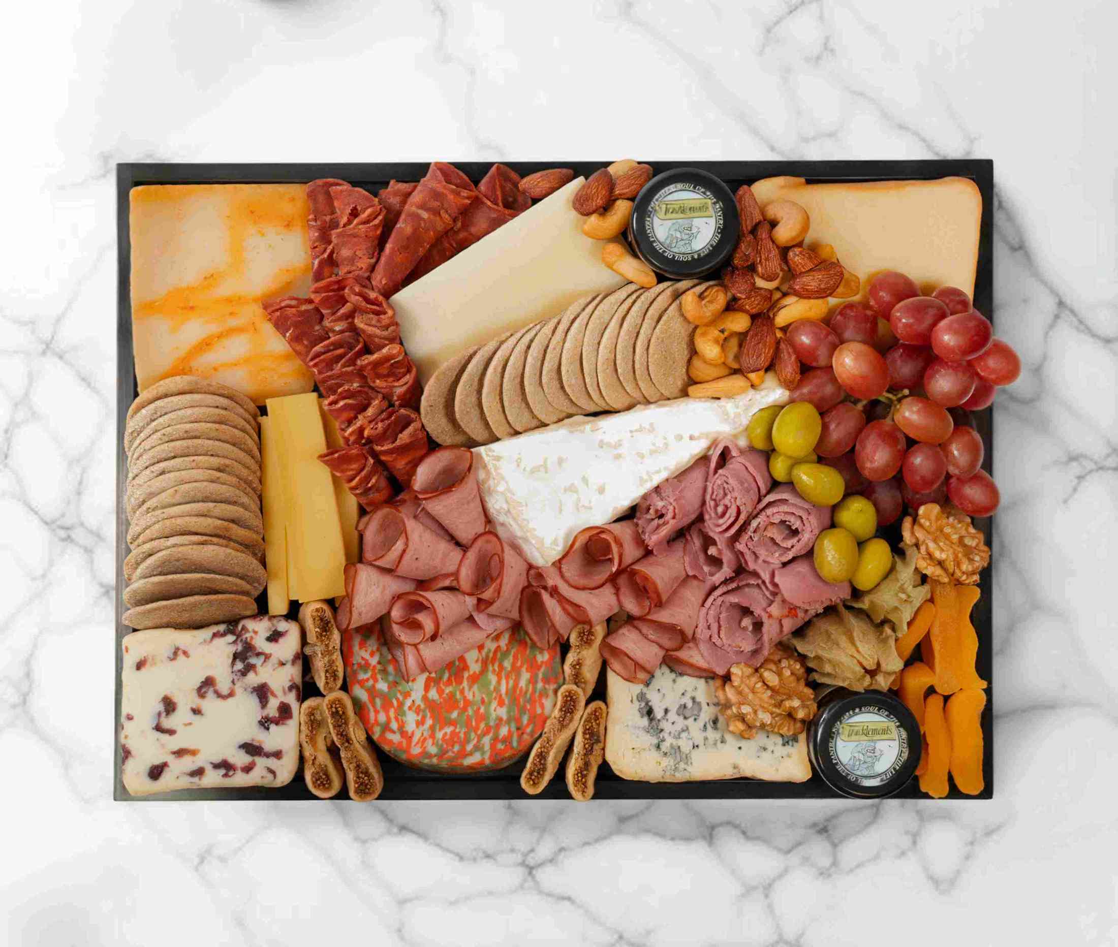 The Cheese Man’s signature cheeseboard with assorted cheeses, charcuterie, and fruits, serving 5–7 people - AED 289.00 - The Cheese Man Cheese Platter