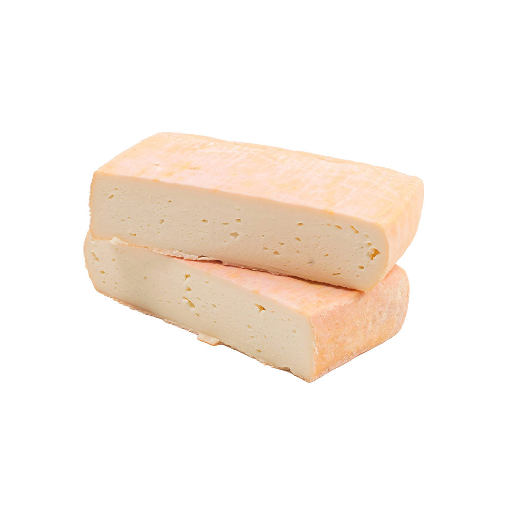 Two pieces of taleggio dop cheese on a white background