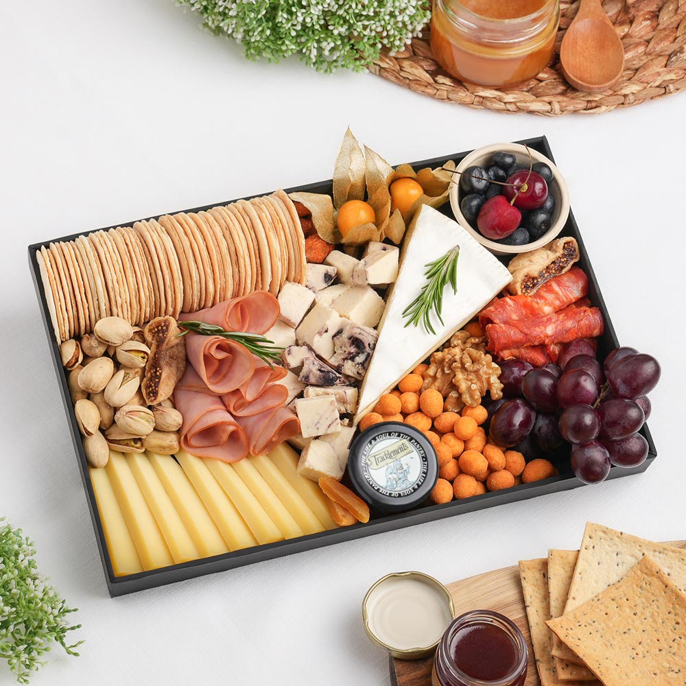 The Signature Cheese Board Small is a handcrafted cheese board featuring creamy Brie, cranberry-infused cheese, semi-hard cheese, rolled turkey cold cuts, beef salami, artisan crackers, and thoughtfully curated gourmet accompaniments, beautifully arranged for sharing and entertaining. Explore handcrafted cheese platters in Dubai with The Cheese Man. Expertly prepared and freshly delivered across the UAE.