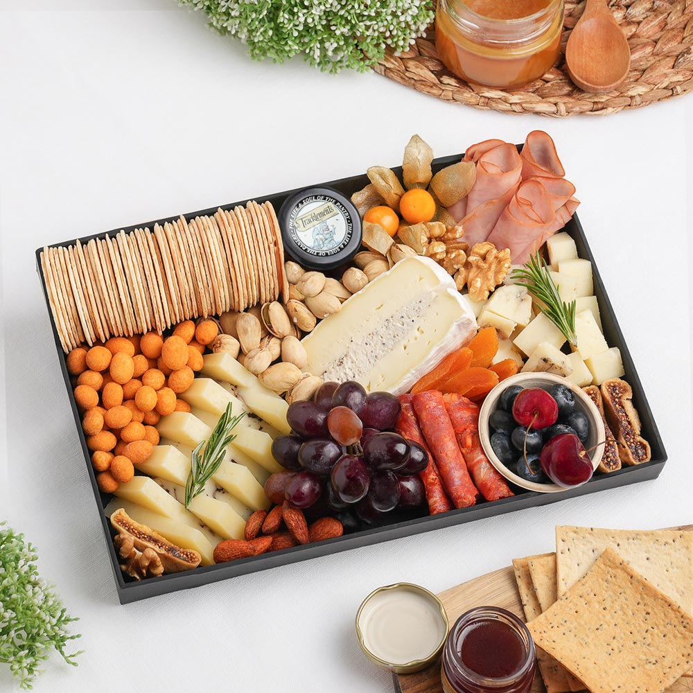 The Truffle Cheese Board Small is a luxurious cheese board featuring creamy Brie with Truffle, Sheep Cheese with Truffle, Cow Truffle Gouda, artisan crackers, red grapes, fresh berries, and carefully selected gourmet accompaniments, beautifully arranged for elegant entertaining. Discover premium truffle cheese and artisan cheese boards in Dubai by The Cheese Man. Freshly prepared for same-day delivery across Dubai.