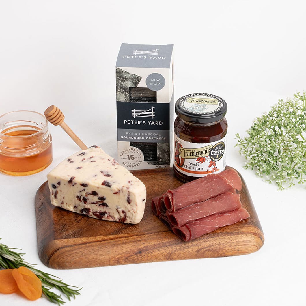 Traditional Wensleydale with cranberries accompanied by premium charcuterie and gourmet accompaniments, celebrating classic British cheesemaking with modern flavour pairings.