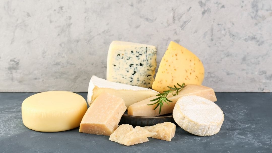 The Cheese Man assortment of artisan cheeses including blue cheese, soft cheese, aged cheese, and semi-hard cheese, showcasing different types of cheese depending on age, consistency and texture.