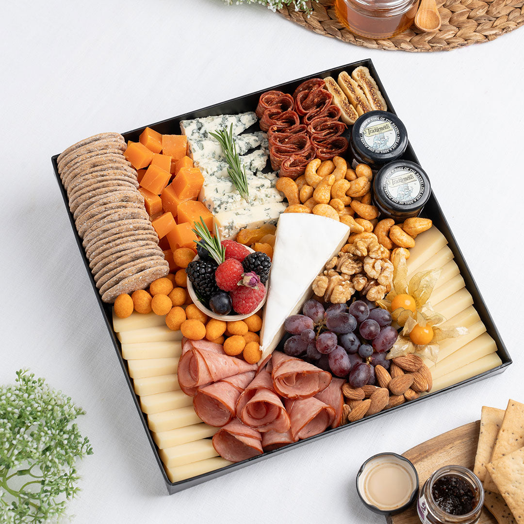 The Cheese Man French cheese platter featuring artisan French cheeses, blue cheese, brie, halal cold cuts, crackers, nuts, grapes, and gourmet accompaniments, curated for luxury cheese boards and charcuterie platters in Dubai. Available for delivery across UAE.