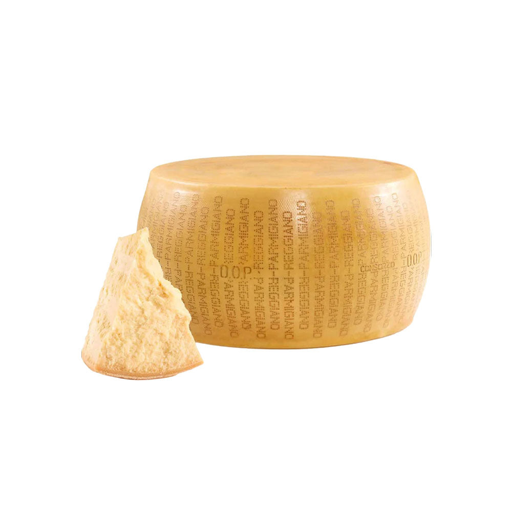Top quality Parmigiano Reggiano. Parmesan cheese wheel with a wedge on a white background