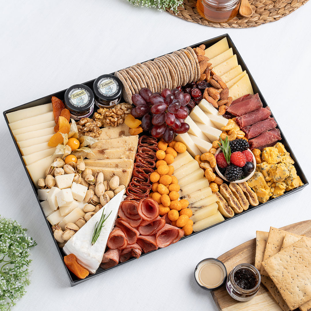 The Cheese Man premium cheese platter featuring artisan cheeses, blue cheese, brie, halal cold cuts, crackers, nuts, grapes, and gourmet accompaniments, curated for luxury cheese boards and charcuterie platters in Dubai. Available for same day delivery in Dubai. Free delivery over AED249.