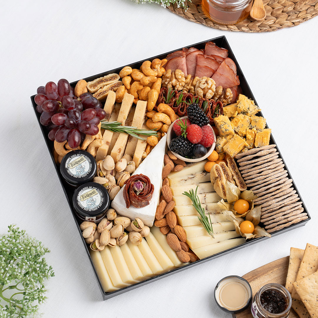 The Cheese Man premium cheese platter featuring artisan cheeses, blue cheese, halal cold cuts, crackers, nuts, grapes, and gourmet accompaniments, curated for luxury charcuterie boards and cheese platters available for delivery across UAE.