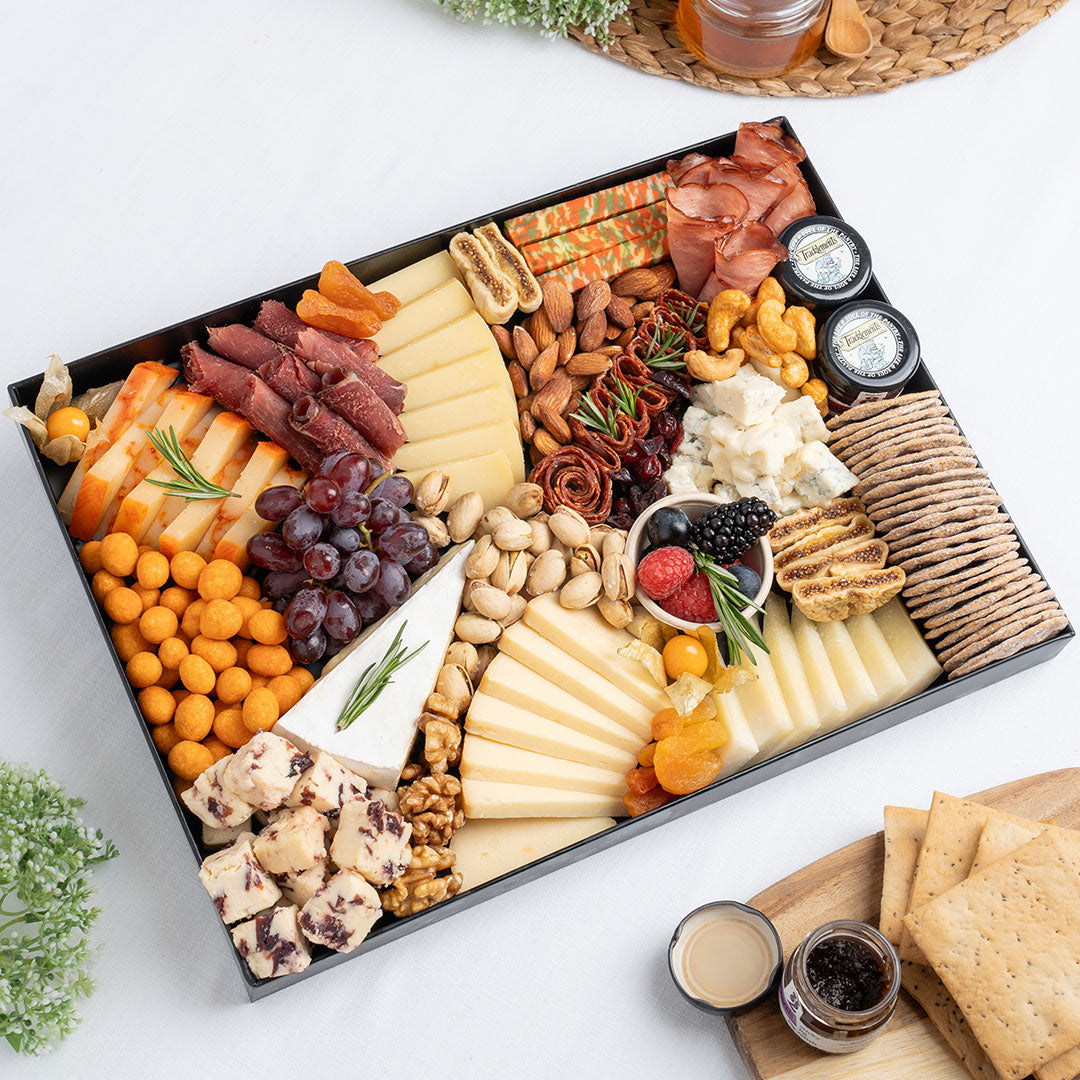 The Cheese Man signature cheese platter featuring artisan cheeses, cranberry cheese, blue cheese, halal cold cuts, crackers, nuts, dried fruits, and gourmet accompaniments, curated for luxury cheese boards and charcuterie platters in Dubai. Available for same day delivery in Dubai. Free delivery over AED249.