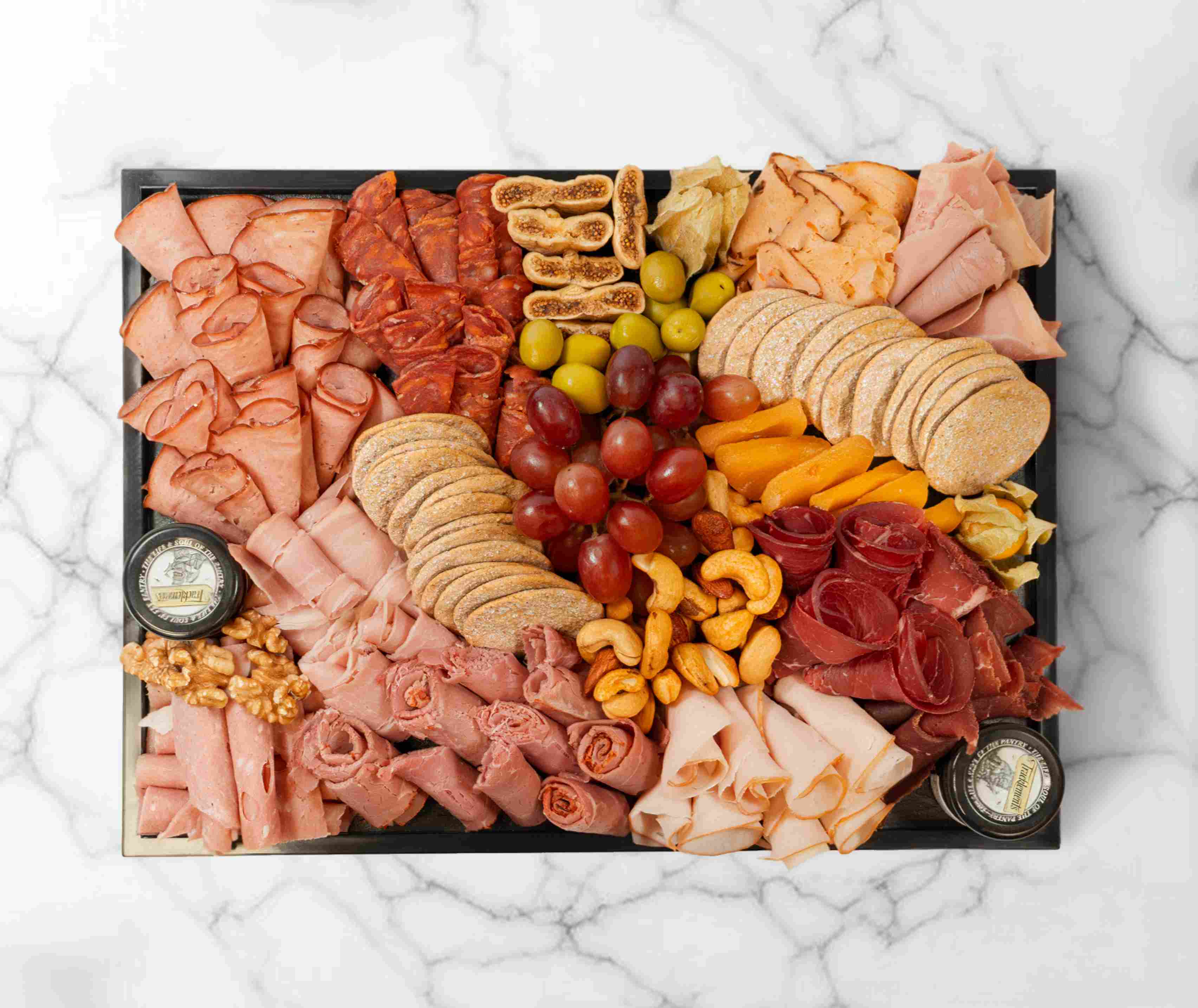 Medium halal charcuterie board with assorted meats, nuts and fruits, serving 5–7 people.