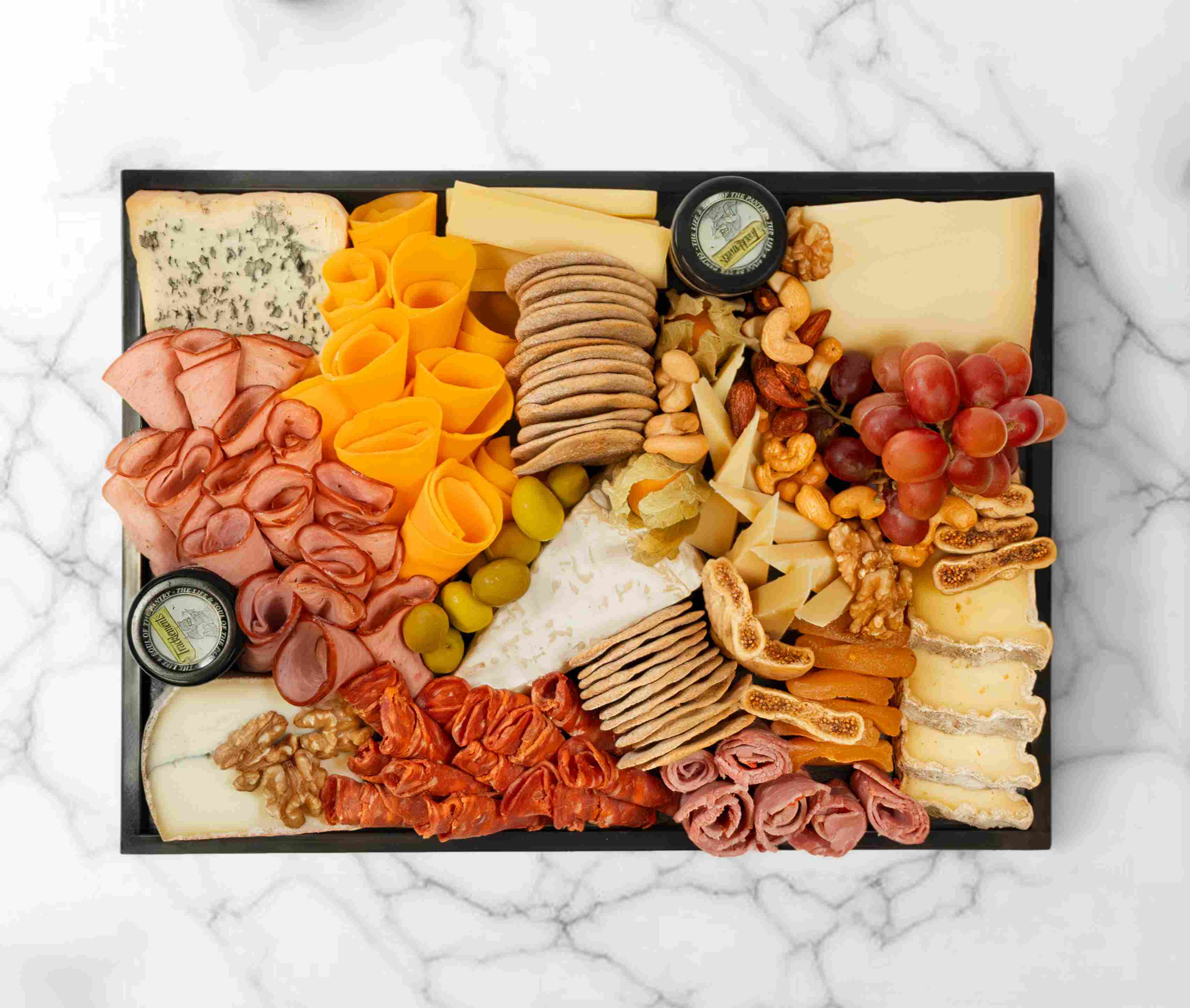 Medium French cheeseboard with assorted French cheeses, charcuterie, and fruits, serving 5–7 people.