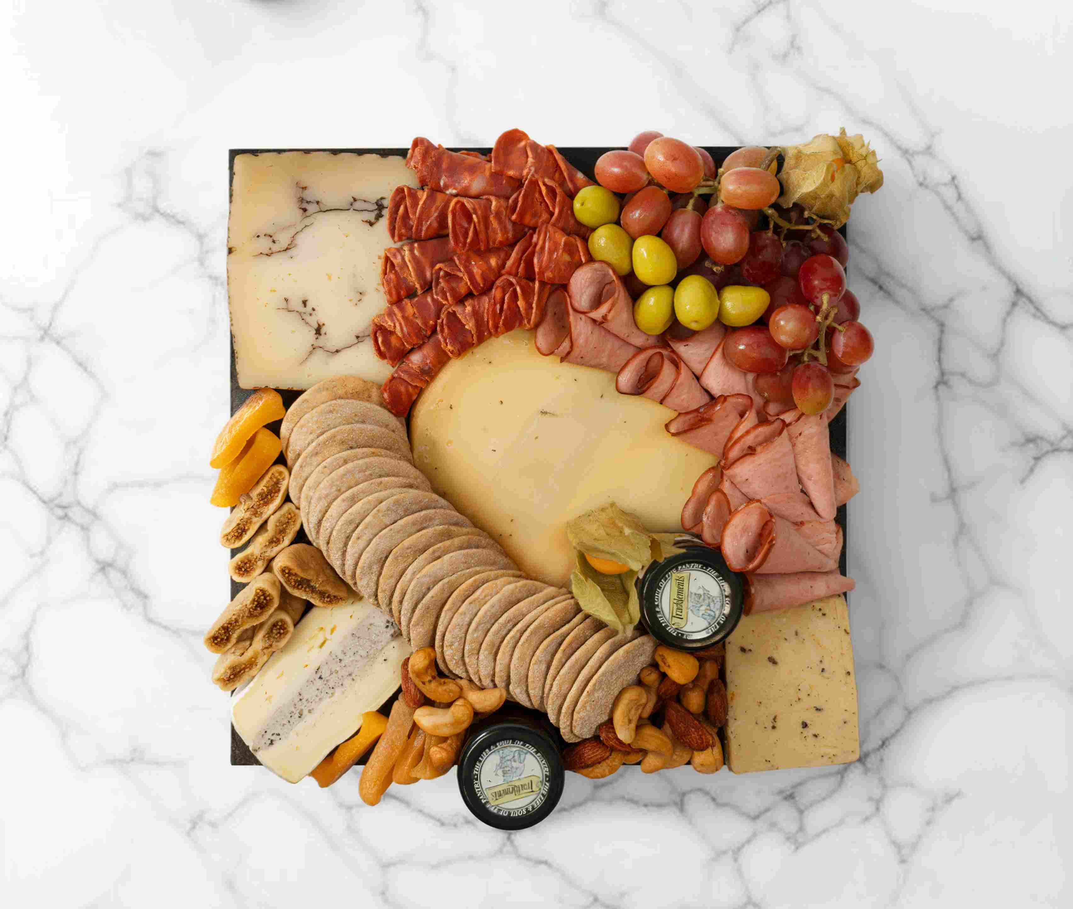 Truffle cheeseboard with truffle-infused cheeses and gourmet pairings, serving 2–4 people.