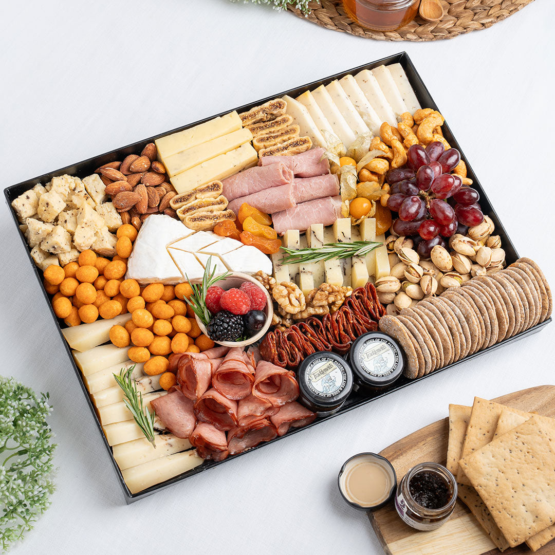 The Cheese Man truffle cheese platter featuring brie, truffle cheese, artisan cheeses, halal cold cuts, crackers, nuts, grapes, figs, and gourmet accompaniments, curated for luxury charcuterie boards and cheese platters in Dubai. Available for delivery across UAE. Free delivery over AED249.