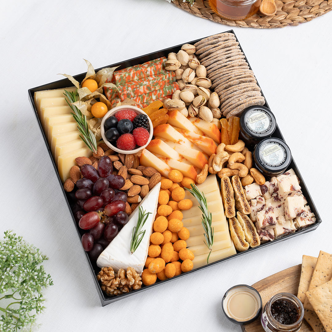 The Cheese Man vegetarian cheese platter featuring artisan cheeses, crackers, nuts, dried fruits, grapes, and gourmet accompaniments, curated for luxury cheese boards and vegetarian charcuterie platters in the Whole UAE.